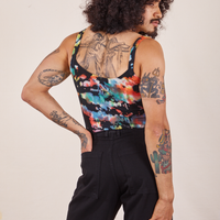 Back view of Cropped Cami in Rainbow Magic Waters and black Western Pants worn by Jesse. They have their right hand in the back pant pocket.