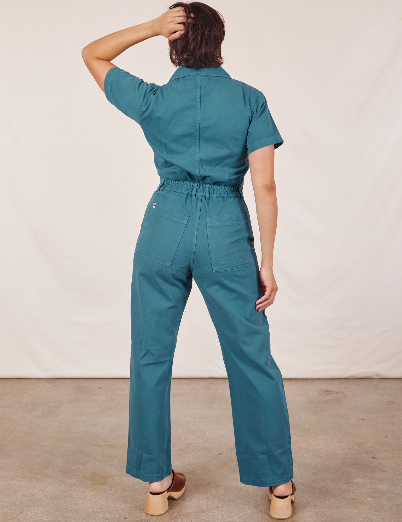 Back view of Short Sleeve Jumpsuit in Marine Blue worn by Tiara