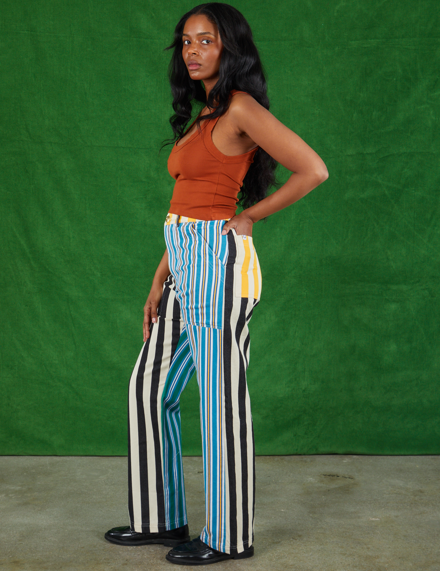 Side view of Mismatched Stripe Work Pants and burnt terracotta Cropped Tank Top