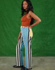 Side view of Mismatched Stripe Work Pants and burnt terracotta Cropped Tank Top