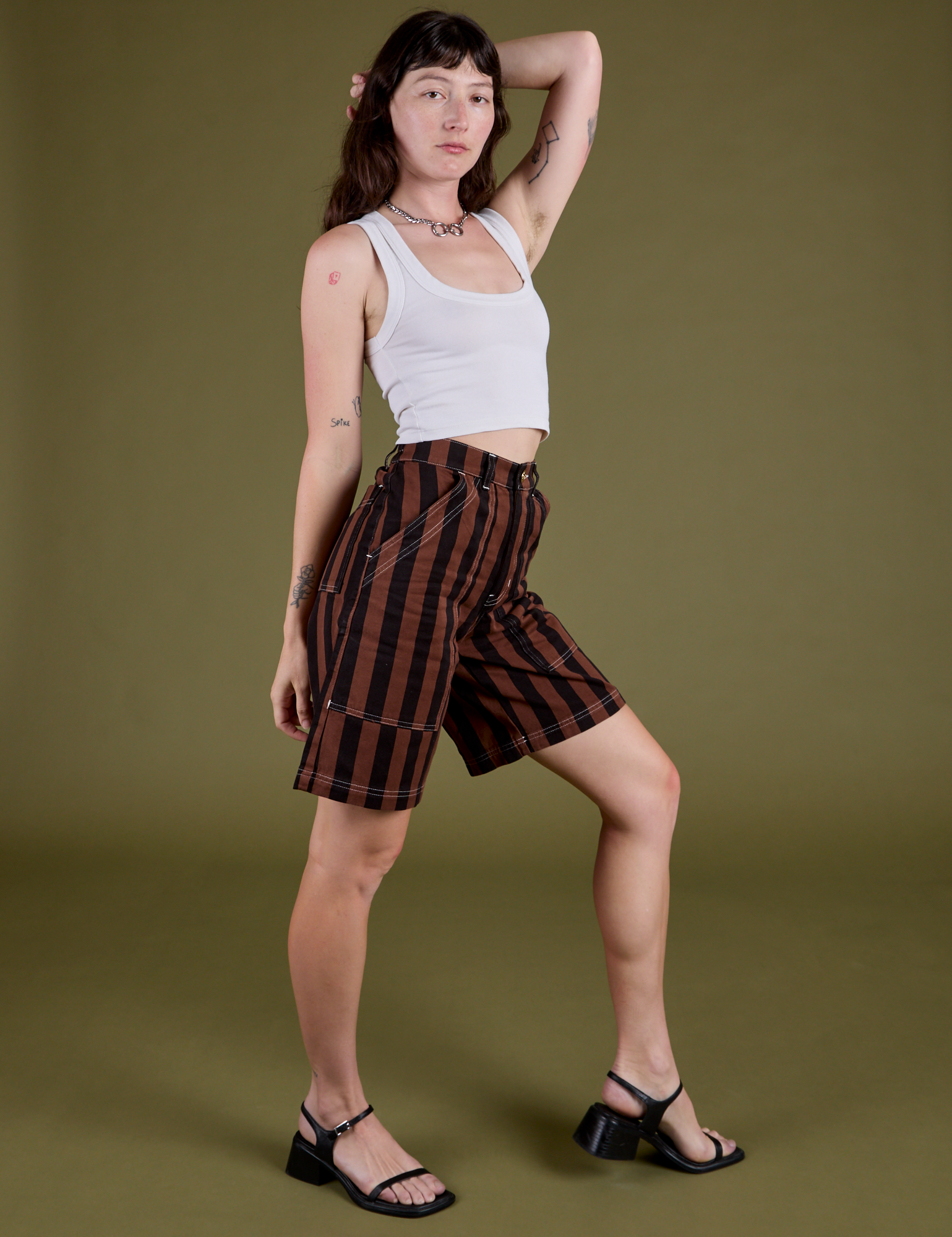 Side view of Longline Work Shorts in Fudgesicle Brown and vintage tee white Cropped Tank on Alex