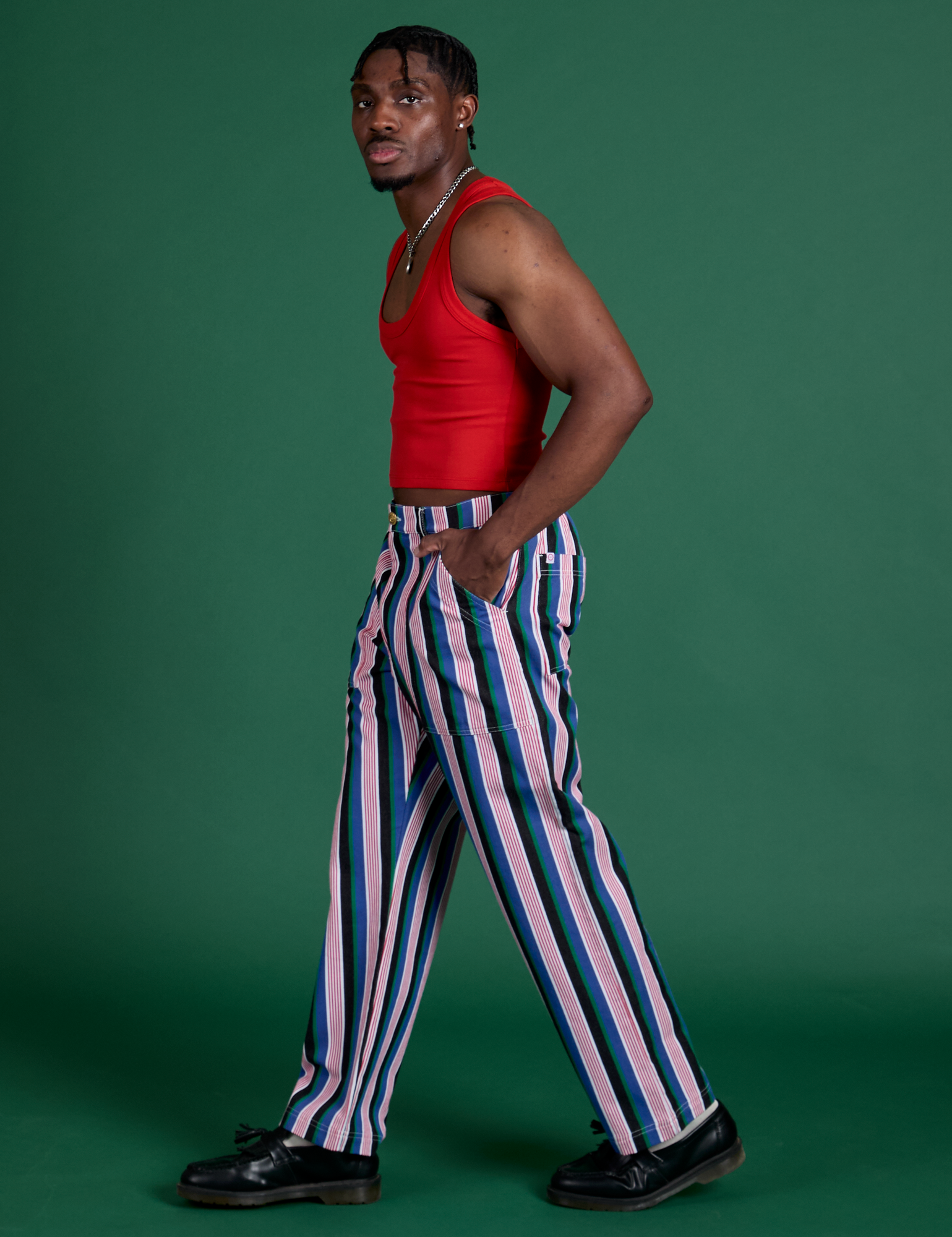Side view of Work Pants in Pacific Stripe and mustang red Cropped Tank on Isaac
