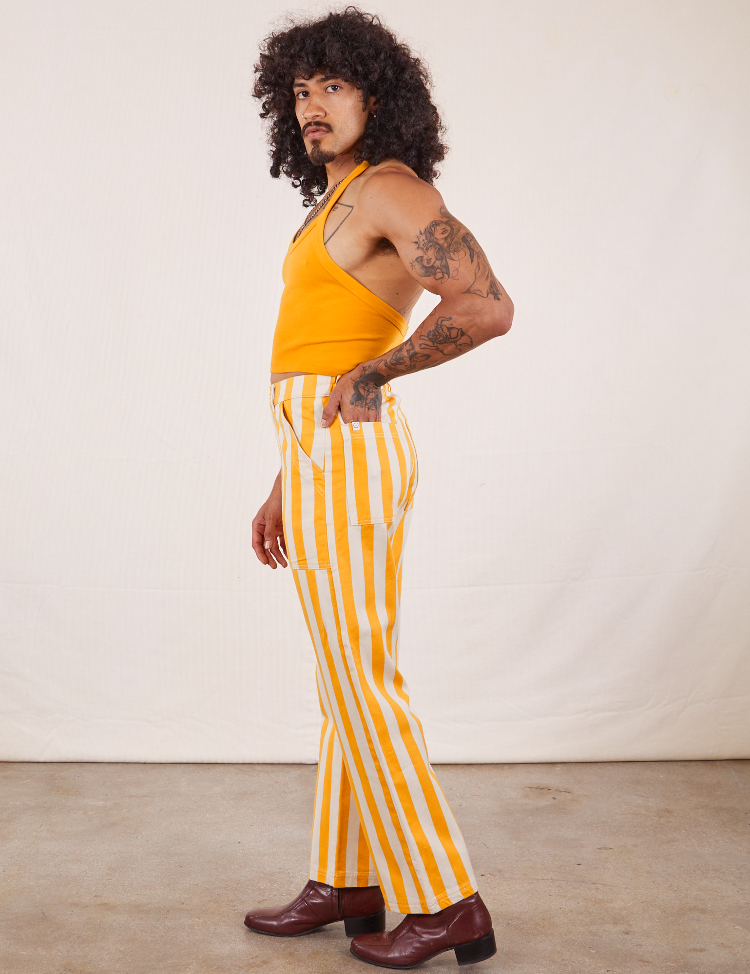 Side view of Work Pants in Lemon Stripe and mustard yellow Halter Top on Jesse