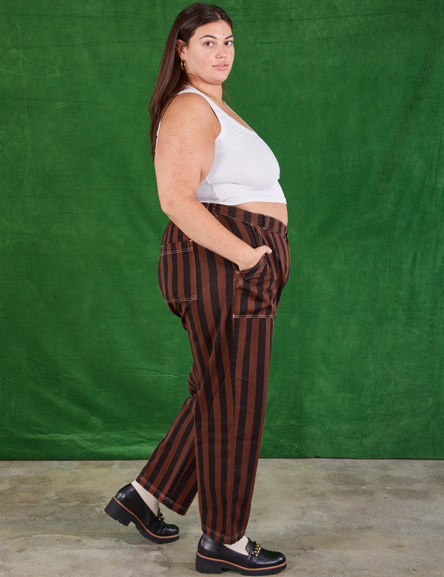 Side view of Black Stripe Work Pants in Fudgesicle Brown and Cropped Tank on Katie