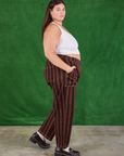 Side view of Black Stripe Work Pants in Fudgesicle Brown and Cropped Tank on Katie