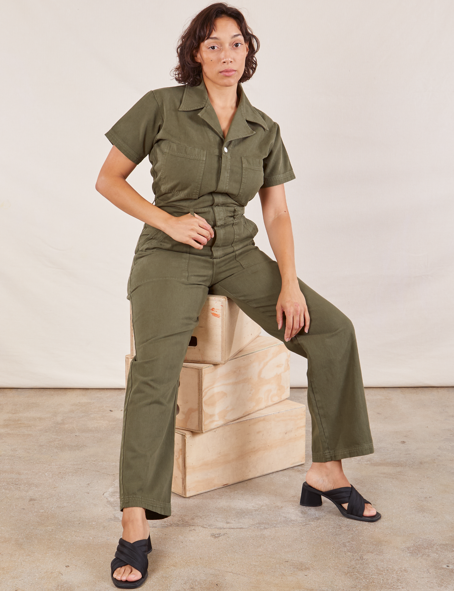 Tiara is wearing Short Sleeve Jumpsuit in Surplus Green