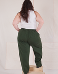 Back view of Heritage Trousers in Swamp Green and vintage off-white Tank Top on Ashley