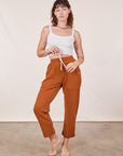 Alex is 5'8" and wearing XXS Cropped Rolled Cuff Sweatpants in Burnt Terracotta paired with vintage off-white Cami
