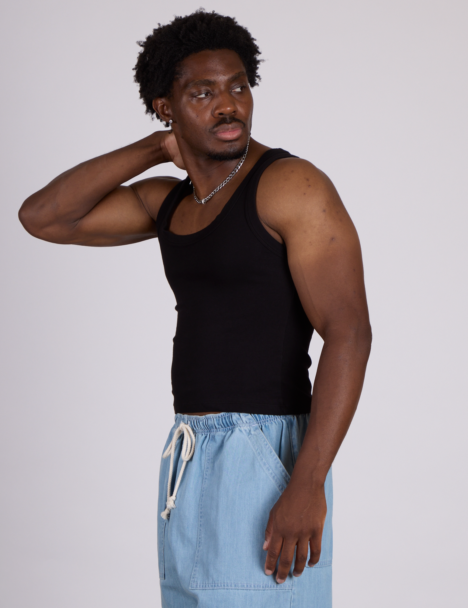 Side view of The Tank Top in Basic Black on Isaac