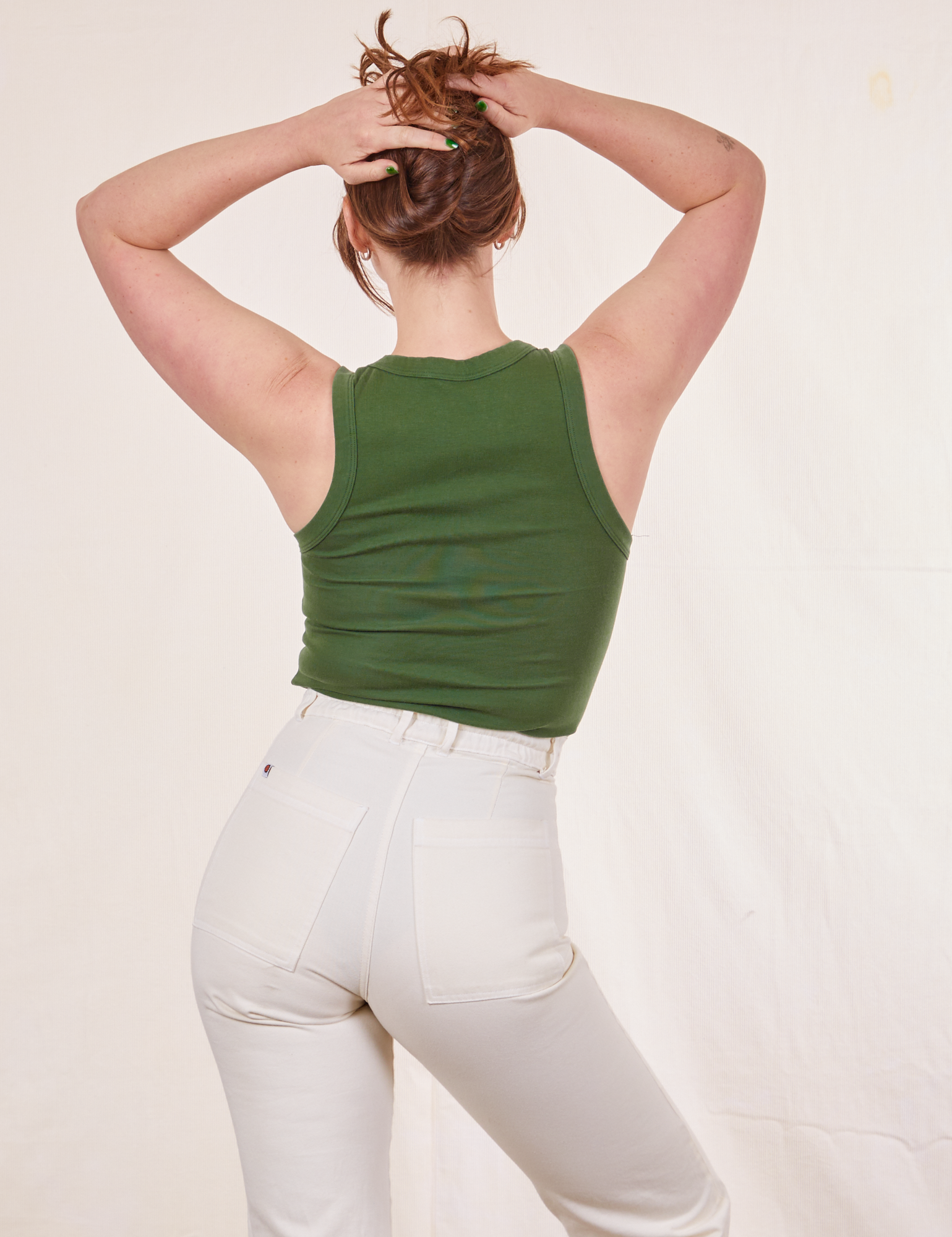 Back view of Tank Top in Dark Emerald Green and vintage off-white Western Pants on Allison