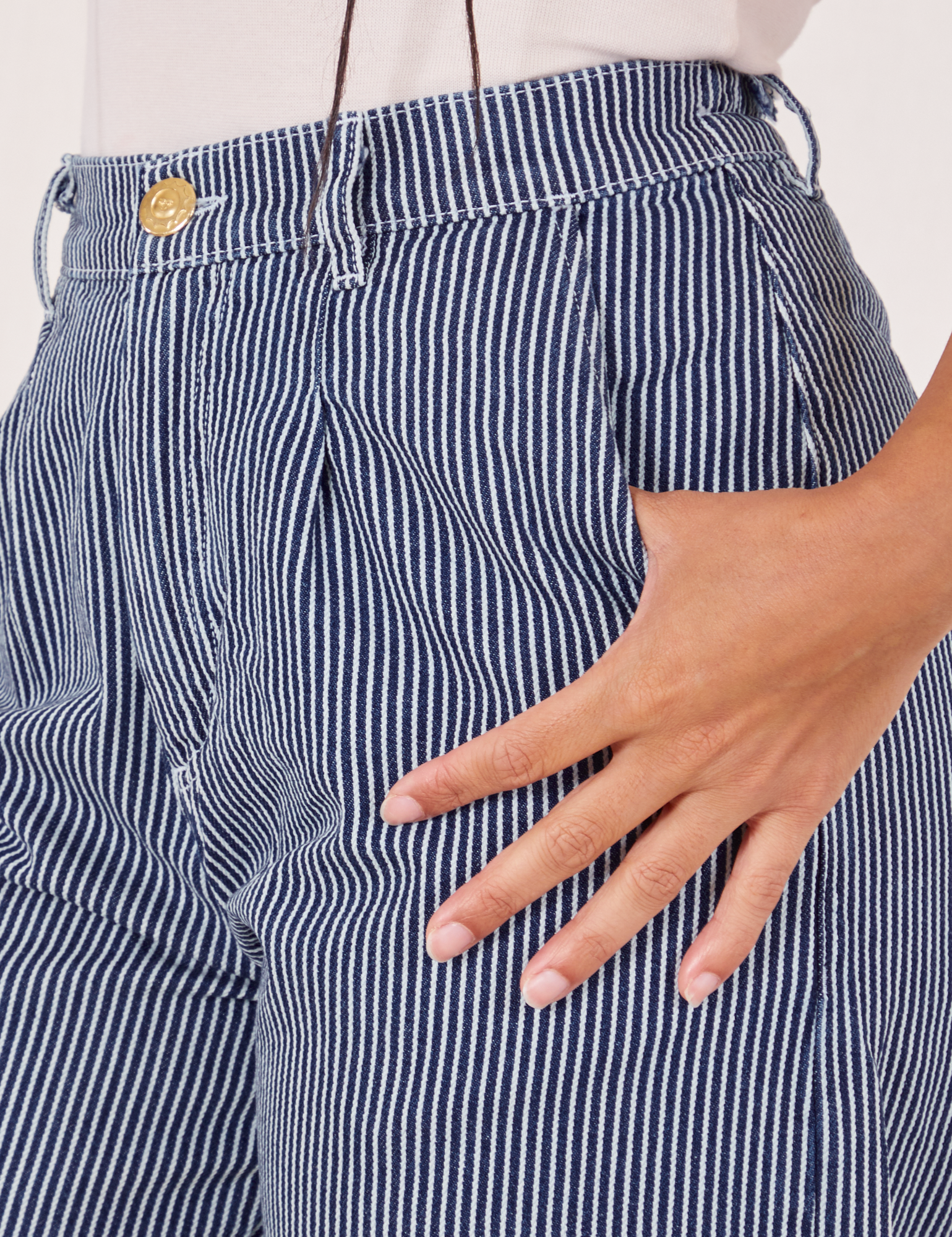 Front pocket close up of Denim Trouser Jeans in Railroad Stripe. Gabi has her hand in the pocket.