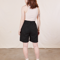Back view of Trouser Shorts in Basic Black and vintage off-white Tank Top worn by Hana