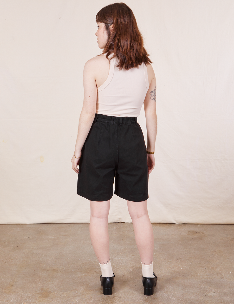Back view of Trouser Shorts in Basic Black and vintage off-white Tank Top worn by Hana
