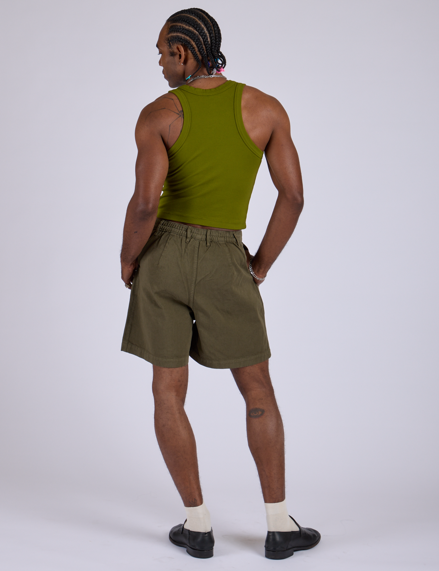 Back view of Pleated Trouser Shorts in Surplus Green and summer olive Racerback Tank on Jerrod