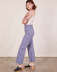Side view of Western Pants in Faded Grape and vintage off-white Tank Top worn by Alex