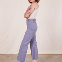 Side view of Western Pants in Faded Grape and vintage off-white Tank Top worn by Alex