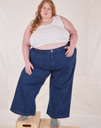 Catie is 5'11" and wearing 4XL Indigo Wide Leg Trousers in Dark Wash paired with vintage off-white Cropped Tank Top