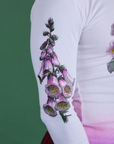 Close up of screen-print flower on sleeve of Floral Long Sleeve Baby Tee in Pink