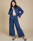 Alex is wearing Indigo Denim Work Jacket in Dark Wash and dark wash Indigo Wide Leg Trousers