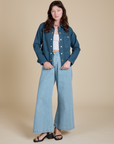 Alex is wearing Denim Work Jacket in French Blue and light wash Indigo Wide Leg Trousers