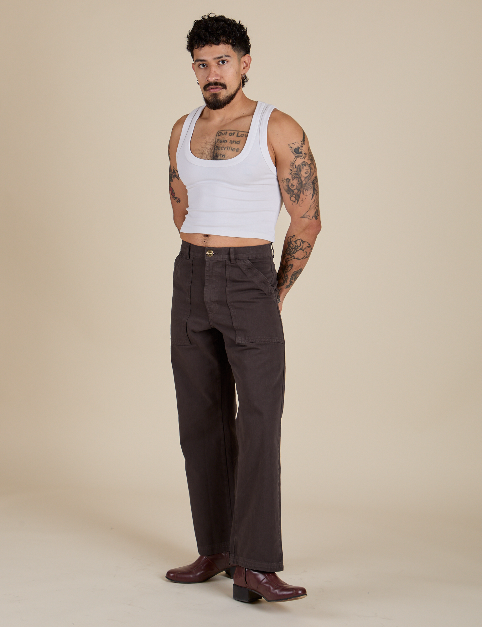 Angled front view of Work Pants in Espresso Brown and vintage tee white Cropped Tank on Jesse