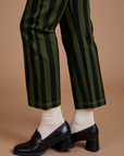 Black Stripe Work Pants in Evergreen pant leg side view close up on Alex