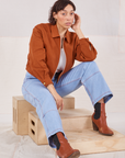 Tiara is wearing Ricky Jacket in Burnt Terracotta and light wash Carpenter Jeans