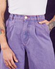 Overdyed Wide Leg Trousers in Faded Grape front close up on Jesse. They have their hand in the pocket.