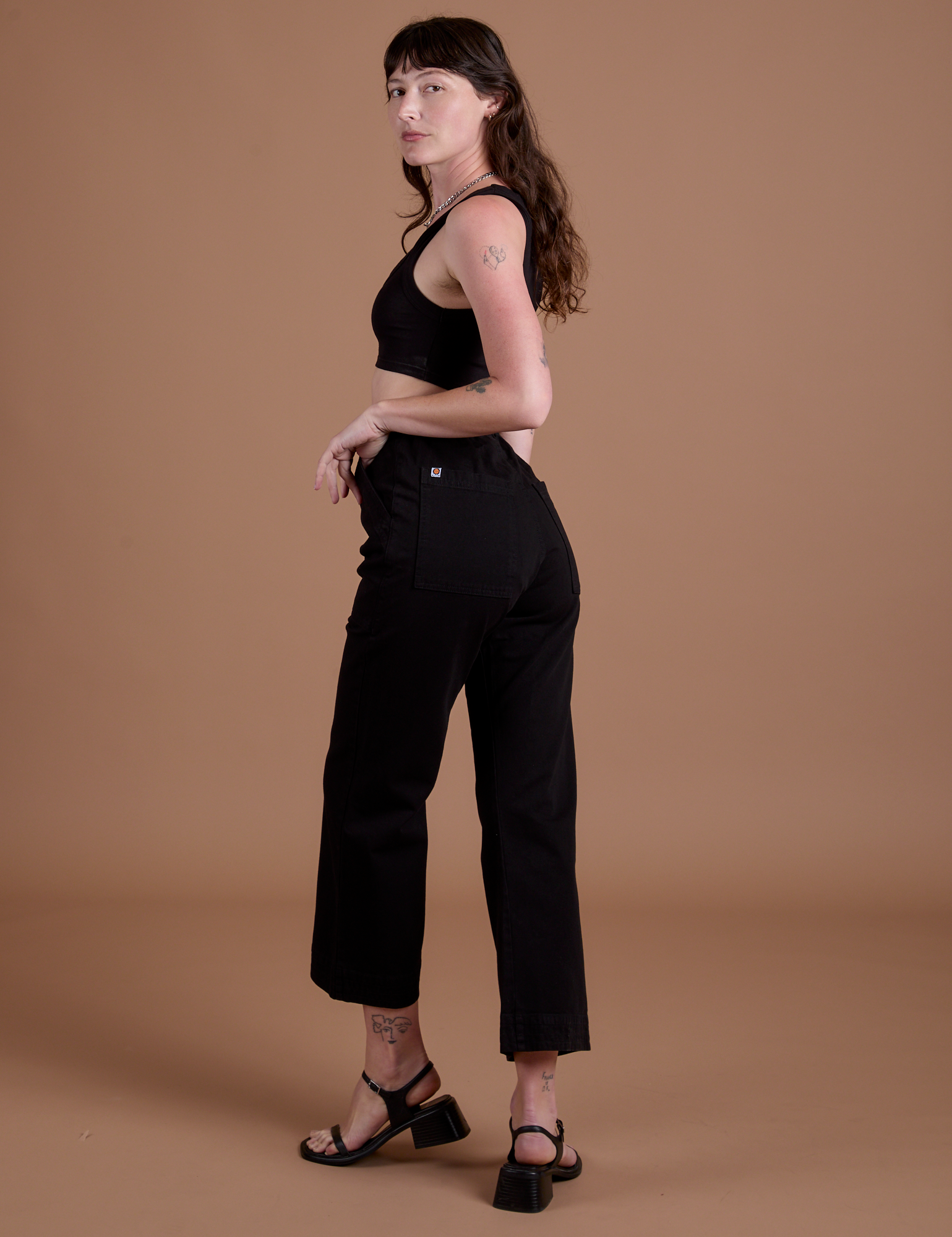 Angled back view of  Action Pants in Basic Black on Alex