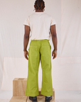 Back view of Action Pants in Gross Green and Organic Vintage Tee in Vintage Tee Off-White