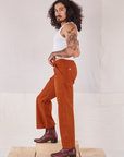 Side view of Action Pants in Burnt Terracotta and Cropped Tank in vintage tee off-white worn by Jesse