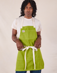 Jerrod is wearing Full Denim Apron in Gross Green