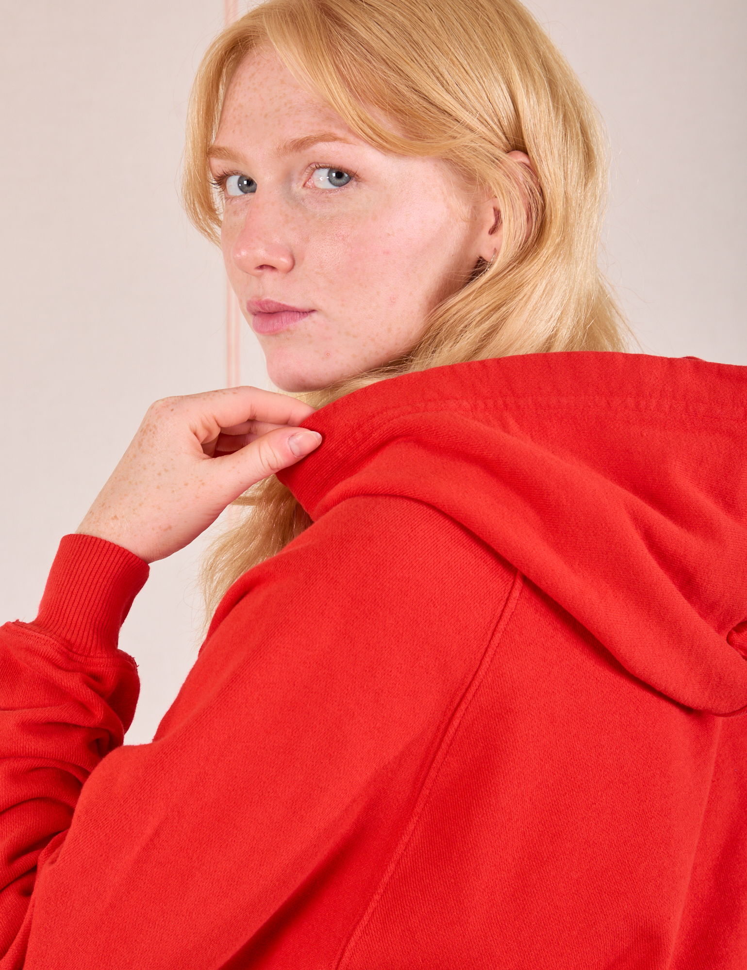 Collegiate Hoodie in Mustang Red side shoulder close up on Margaret