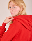 Collegiate Hoodie in Mustang Red side shoulder close up on Margaret