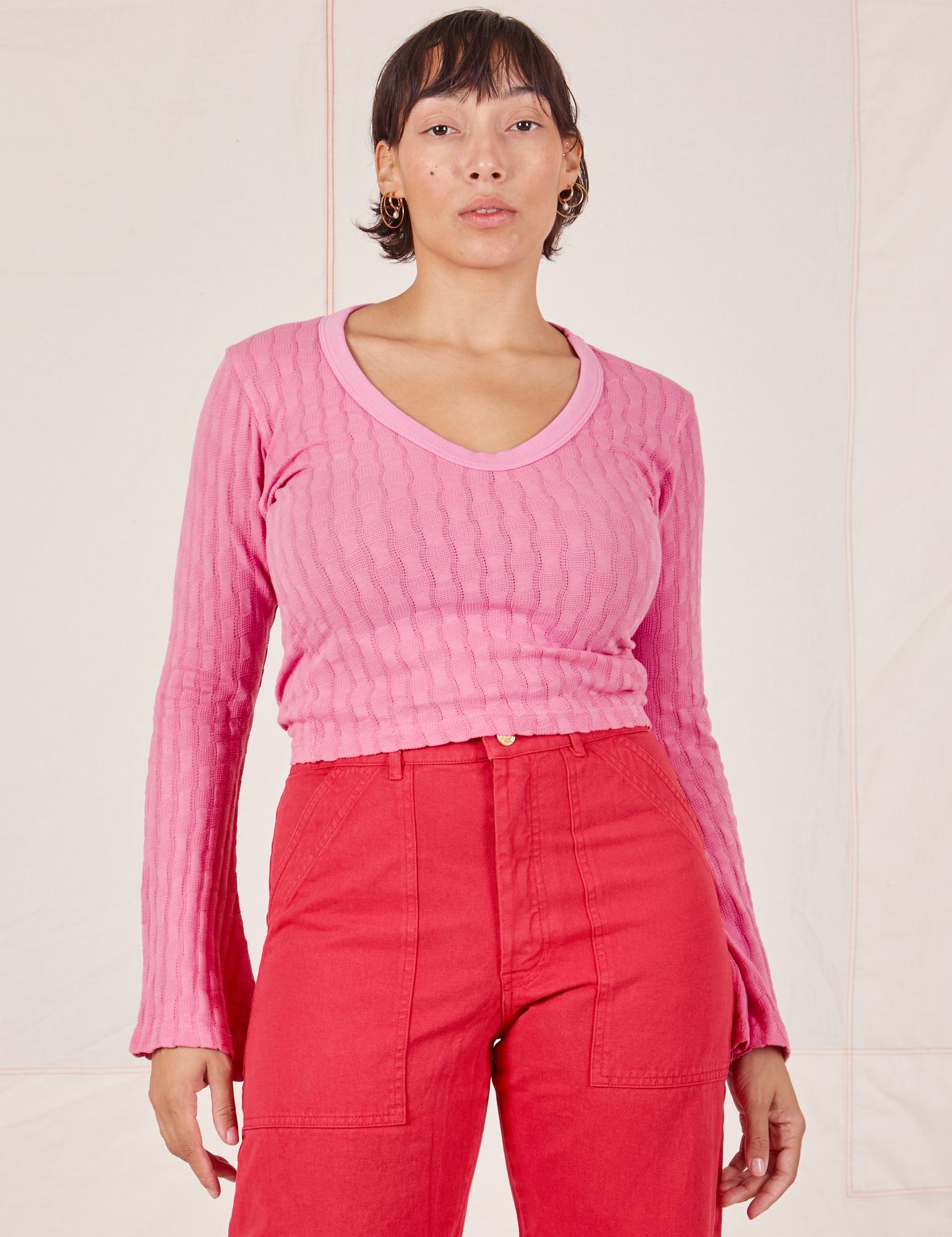 Tiara is wearing S Bell Sleeve Top in Bubblegum Pink paired with hot pink Work Pants