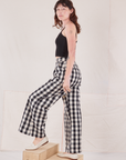 Side view of Wide Leg Trousers in Big Gingham and black Cropped Cami on Alex