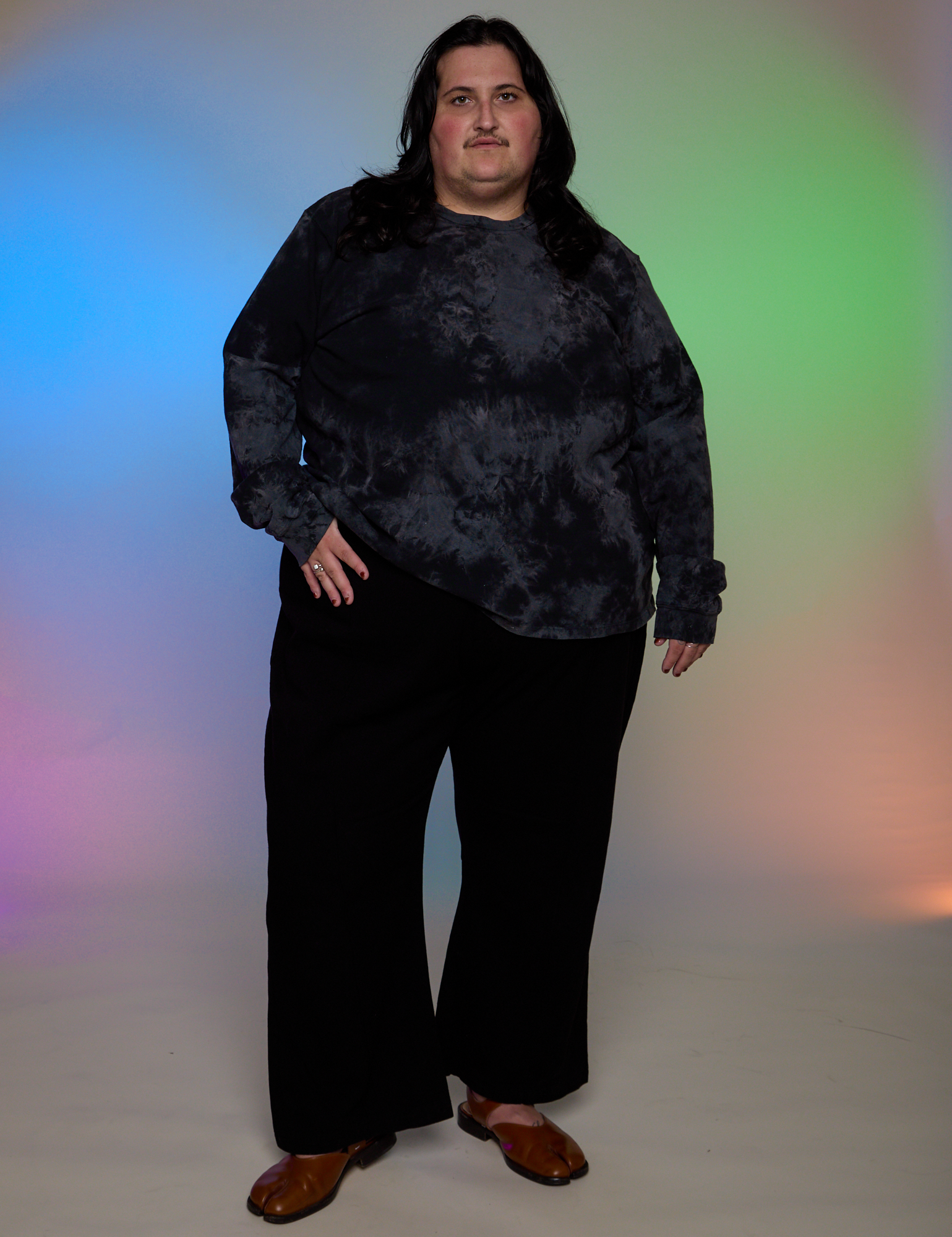 Sam is wearing Magic Waters Long Sleeve Burly Tee in Black