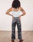 Back view of Black Magic Waters Work Pants and vintage off-white Cropped Cami worn by Jesse