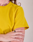 Burly Tee in Golden Yellow sleeve close up on Alex