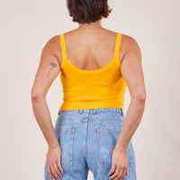Back view of Cropped Cami in Sunshine Yellow and light wash Frontier Jeans worn by Tiara