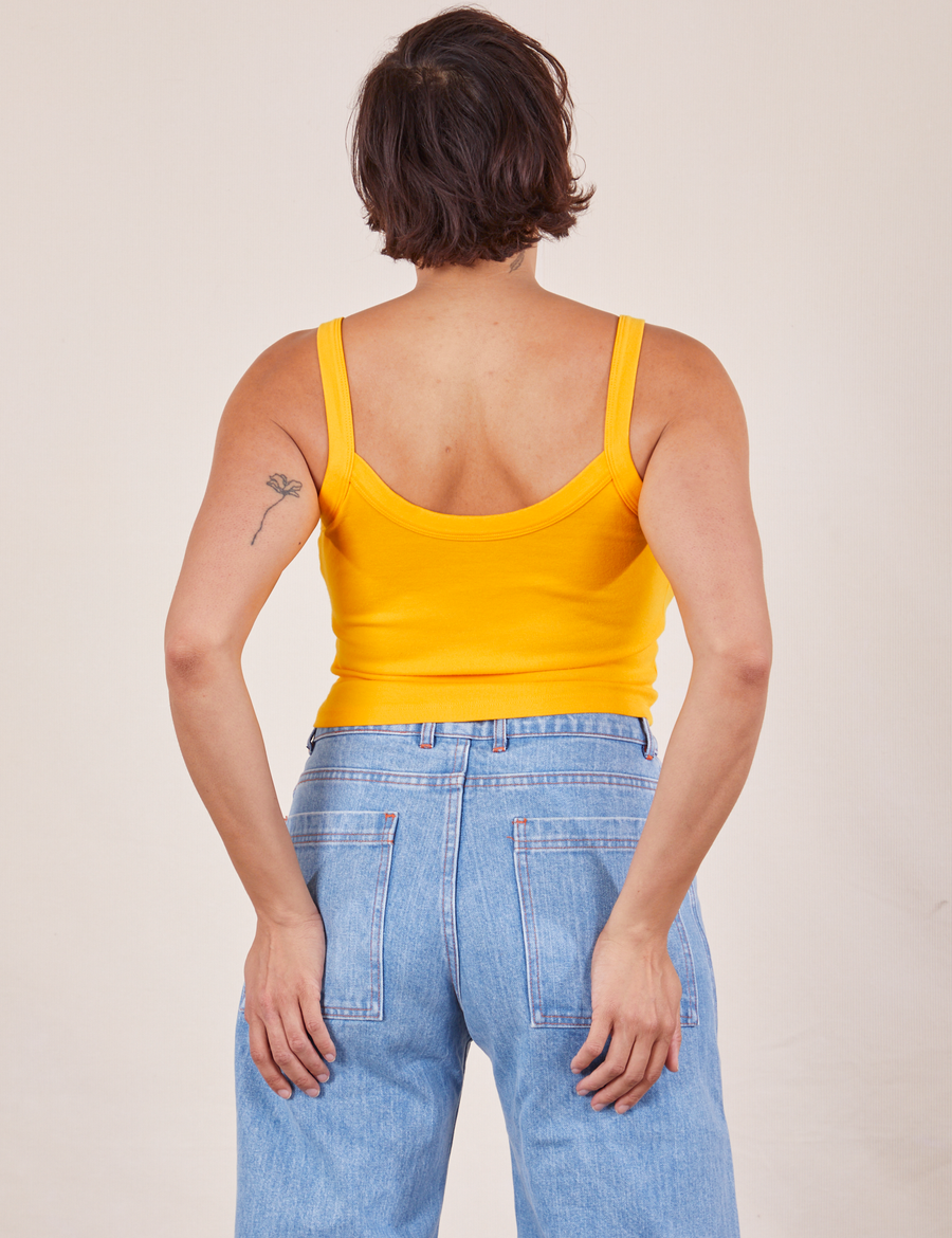 Back view of Cropped Cami in Sunshine Yellow and light wash Frontier Jeans worn by Tiara