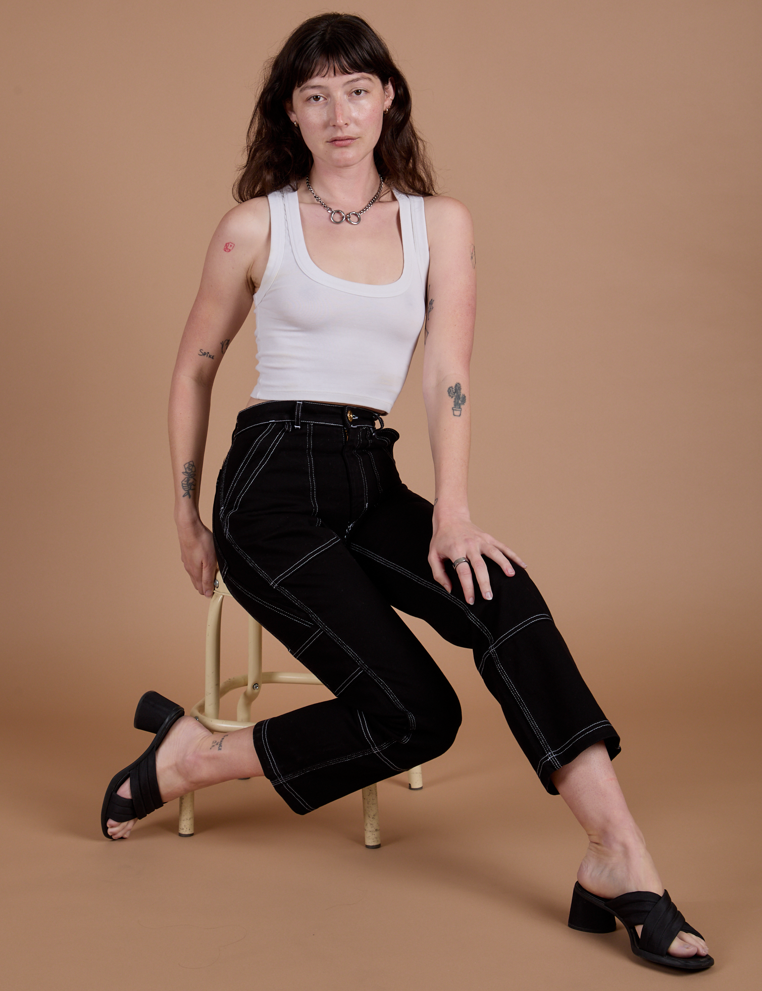 Carpenter Jeans in Black and vintage tee white Cropped Tank worn by Alex