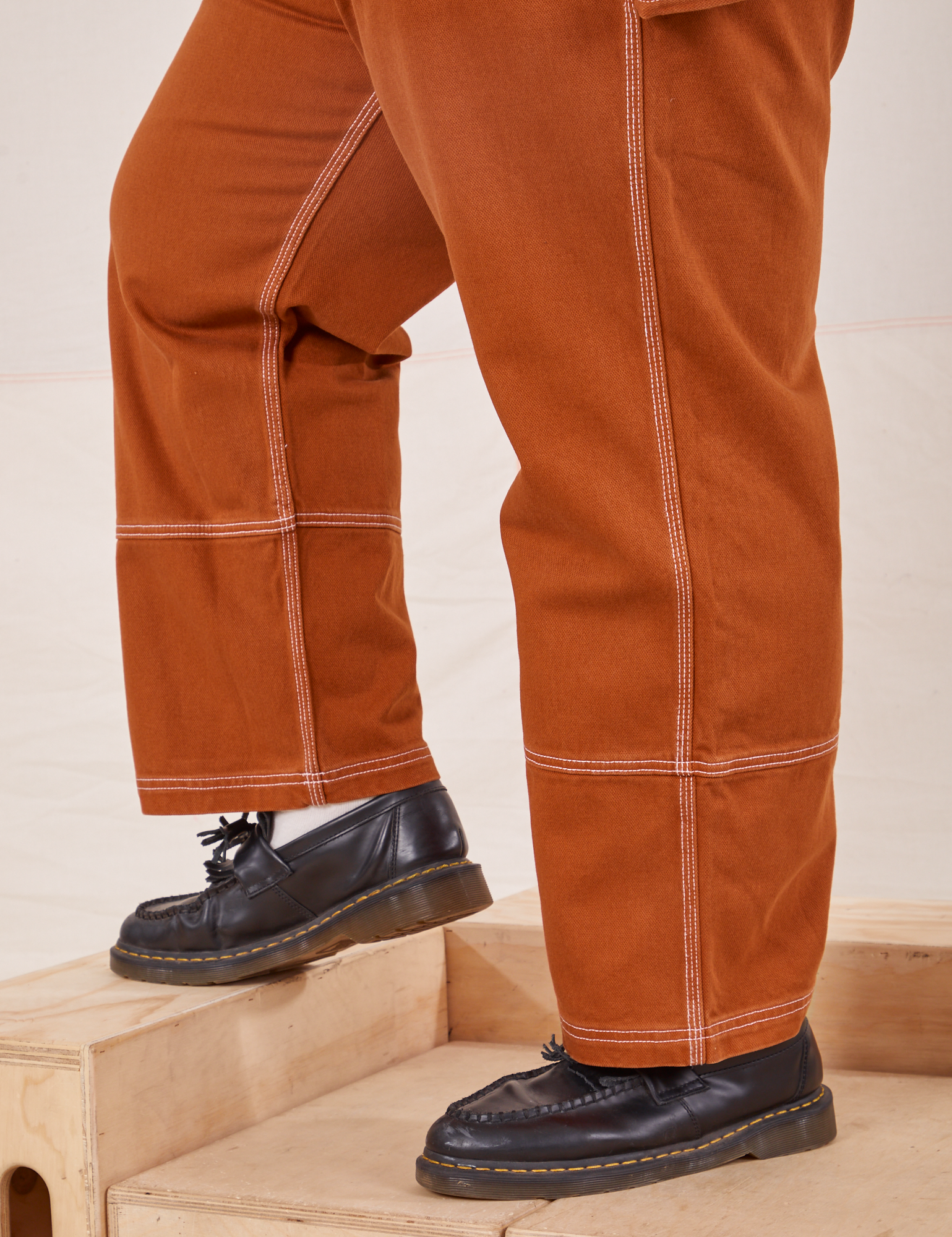 Carpenter Jeans in Burnt Terracotta side close up on Sam