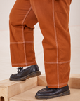 Carpenter Jeans in Burnt Terracotta side close up on Sam