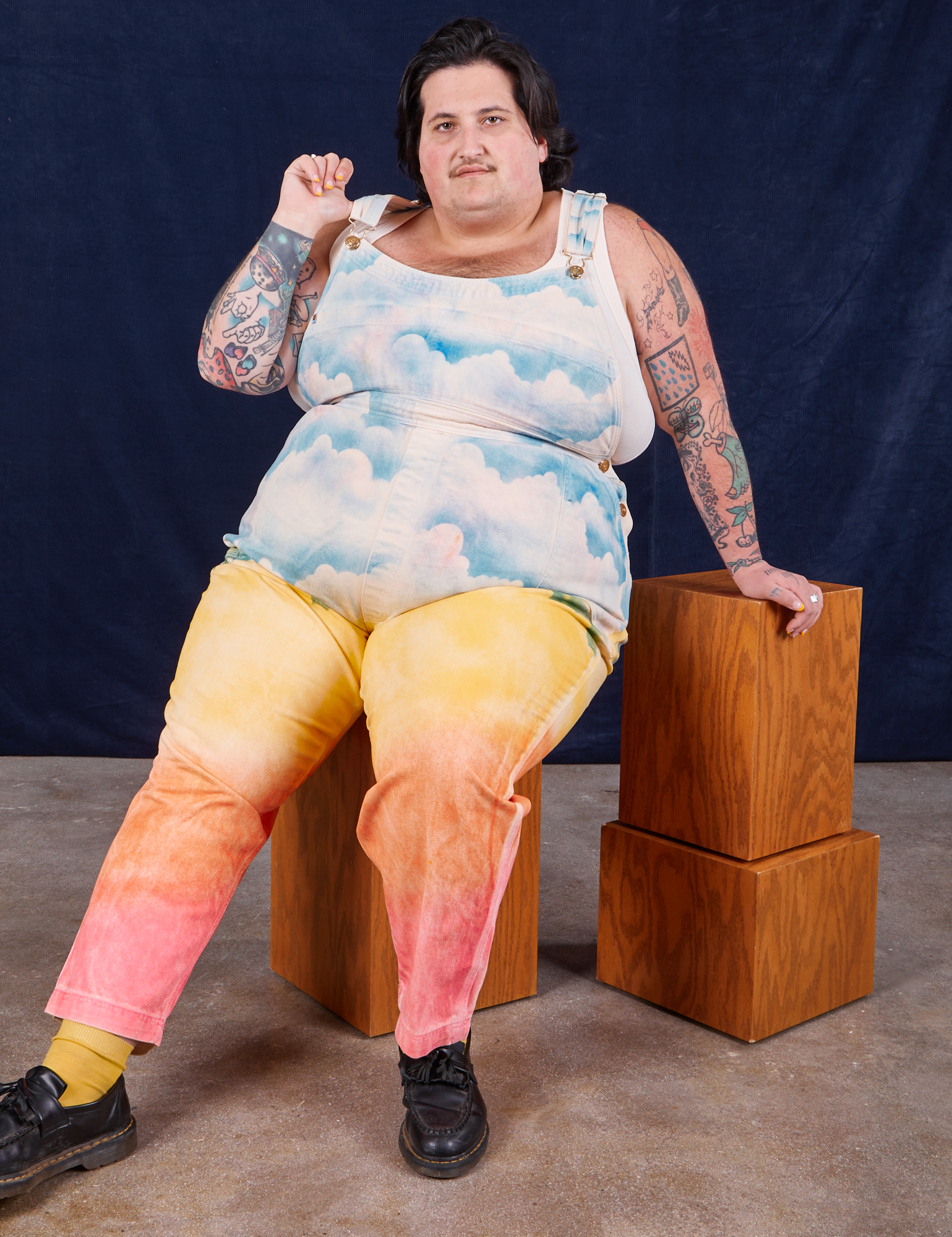 Airbrush Overalls worn by Sam sitting on a wooden box