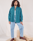 Jesse is wearing Corduroy Overshirt in Marine Blue paired with light wash Denim Trouser Jeans