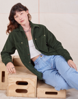 Alex is wearing Corduroy Overshirt in Swamp Green with a vintage off-white Cami underneath paired with light wash Denim Trouser Jeans
