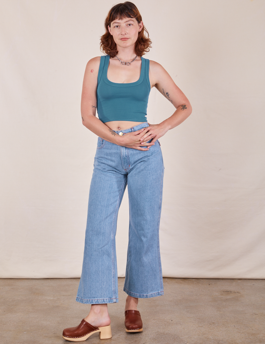 Alex is wearing Cropped Tank Top in Marine Blue paired with light wash Sailor Jeans