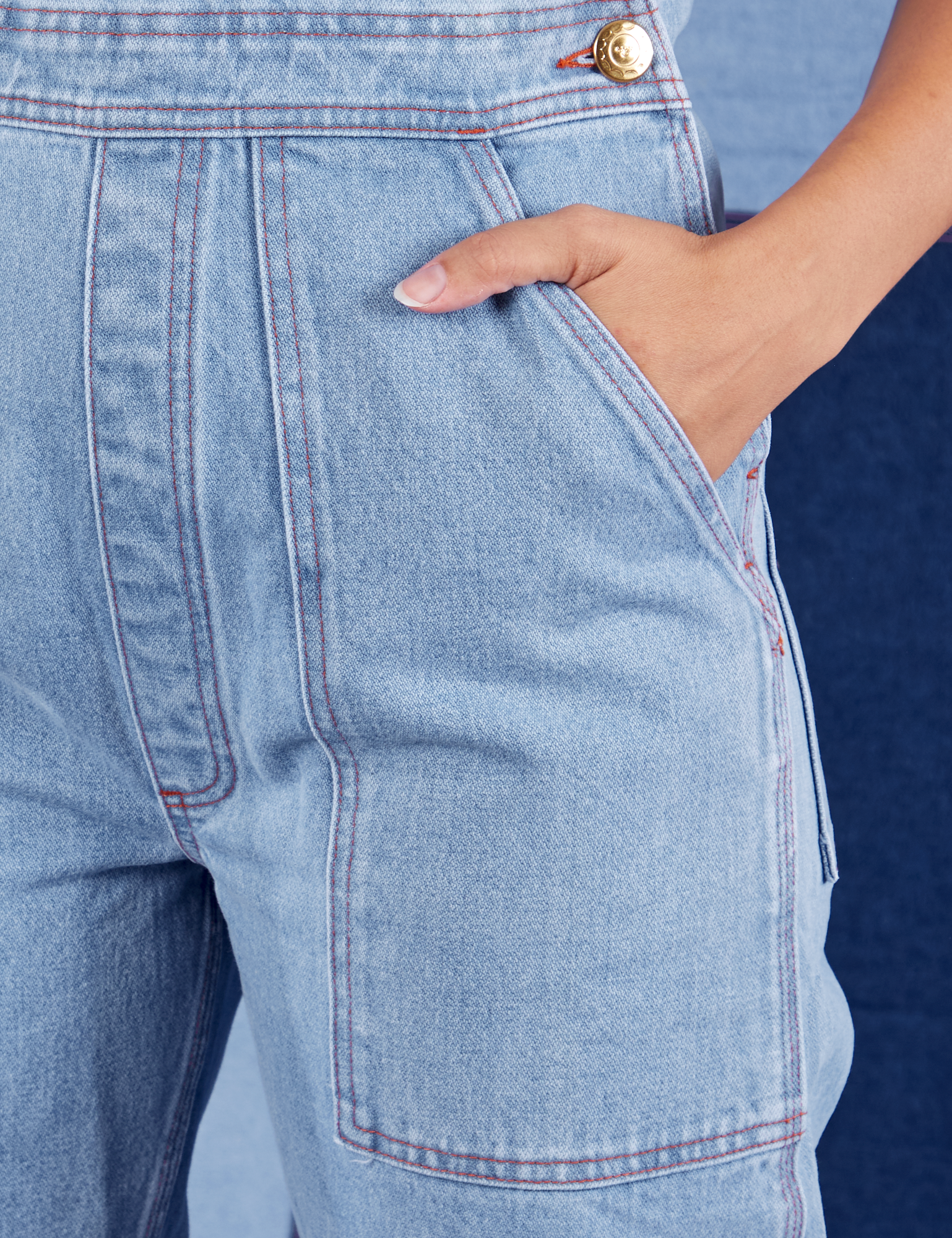 Indigo Denim Original Overalls in Light Wash front pocket close up. Tiara has her hand in the pocket.