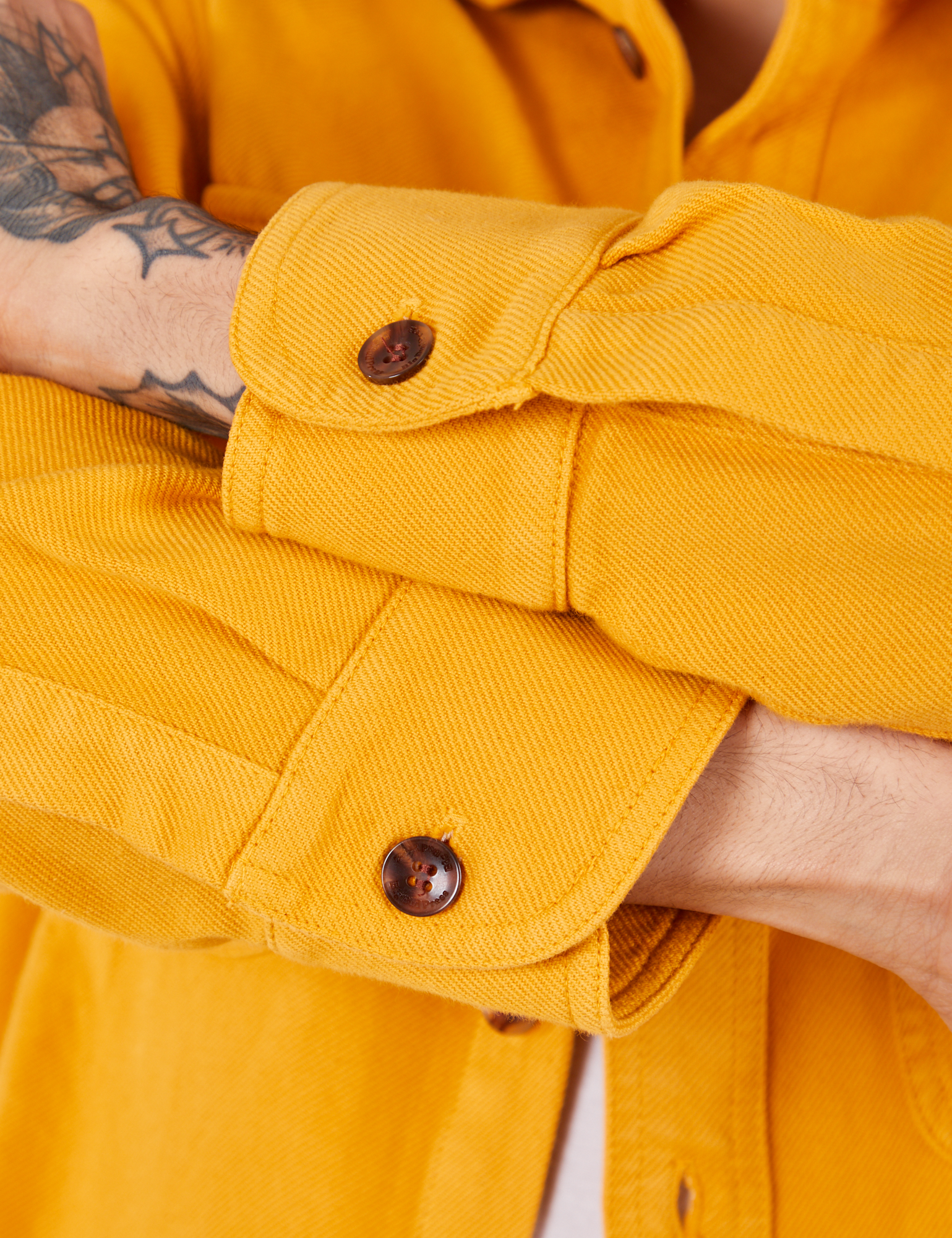 Sleeve cuff close up of Flannel Overshirt in Mustard Yellow on Jesse